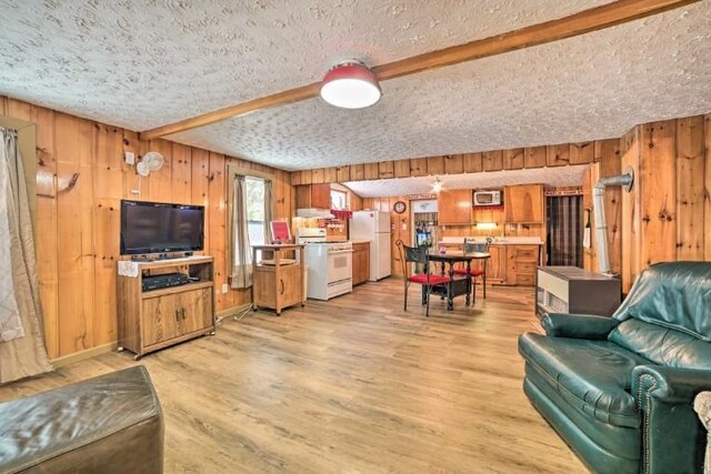 4290 Clark St, Lewiston, MI 49756 - living area featuring wood walls, a textured ceiling, light wood-type flooring, and beam ceiling