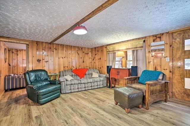 4290 Clark St, Lewiston, MI 49756 - living area featuring a textured ceiling, wood finished floors, wooden walls, and radiator