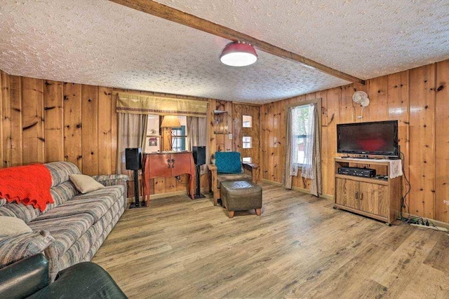 4290 Clark St, Lewiston, MI 49756 - living room featuring wood finished floors, a textured ceiling, wooden walls, and beam ceiling