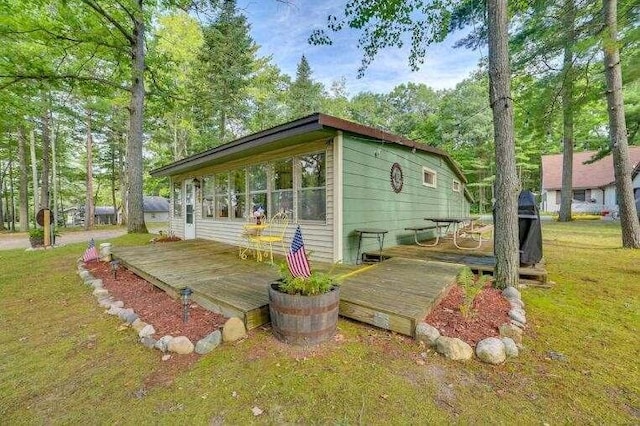 4290 Clark St, Lewiston, MI 49756 - exterior space with a deck and a lawn
