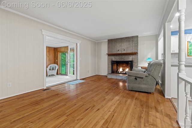 36963 Heatherton Dr, Farmington, MI 48335 - living area featuring light wood finished floors, healthy amount of natural light, a fireplace, and ornamental molding