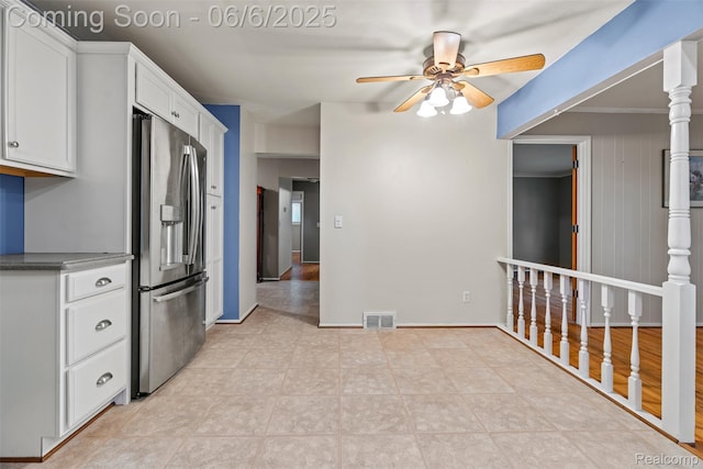 36963 Heatherton Dr, Farmington, MI 48335 - kitchen featuring stainless steel fridge, a ceiling fan, white cabinetry, light tile patterned flooring, and baseboards