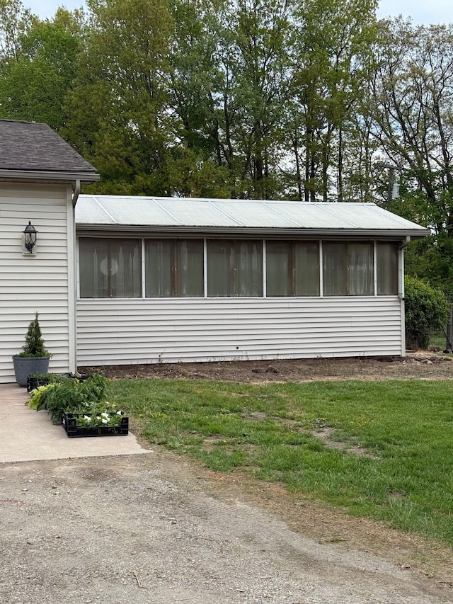 6523 Jones Rd, North Branch, MI 48461 - view of front of home featuring a sunroom and a front lawn