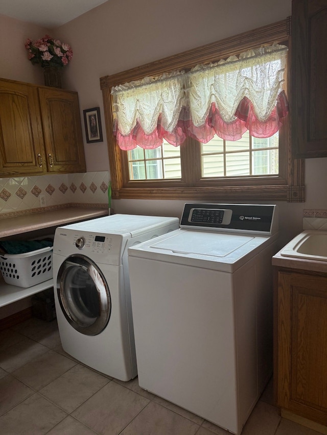 6523 Jones Rd, North Branch, MI 48461 - laundry room with cabinet space, washing machine and clothes dryer, and light tile patterned floors