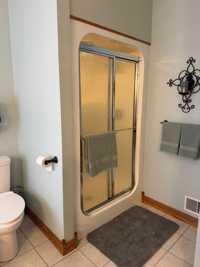 6523 Jones Rd, North Branch, MI 48461 - bathroom with tile patterned floors, a stall shower, toilet, and baseboards