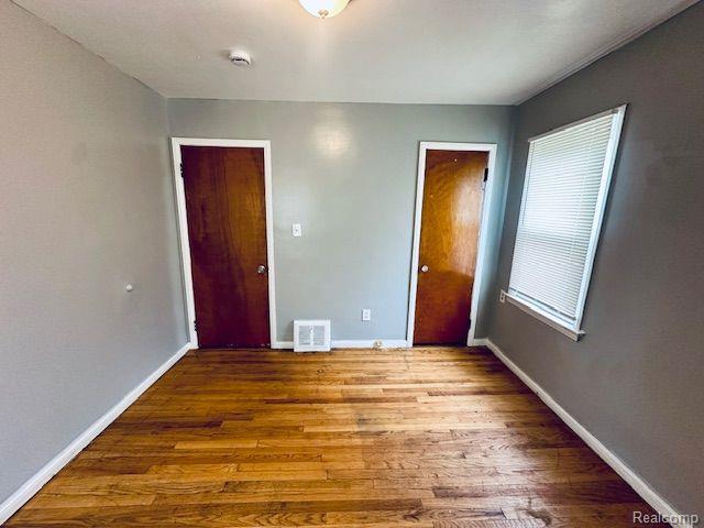 20250 Winthrop St, Detroit, MI 48235 - unfurnished bedroom featuring wood finished floors and baseboards