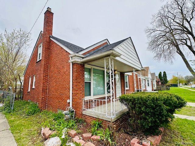 20250 Winthrop St, Detroit, MI 48235 - view of front of house featuring brick siding, covered porch, and a chimney