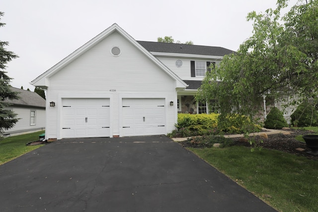 4116 Split Rail Dr, Fenton, MI 48430 - traditional home with asphalt driveway, a garage, and a shingled roof