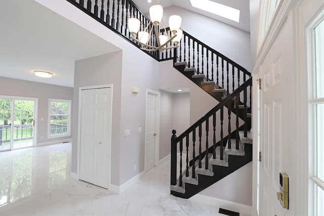 4116 Split Rail Dr, Fenton, MI 48430 - stairs with marble finish flooring, baseboards, a skylight, and a high ceiling