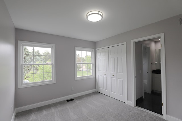 4116 Split Rail Dr, Fenton, MI 48430 - unfurnished bedroom with baseboards, carpet flooring, and a closet