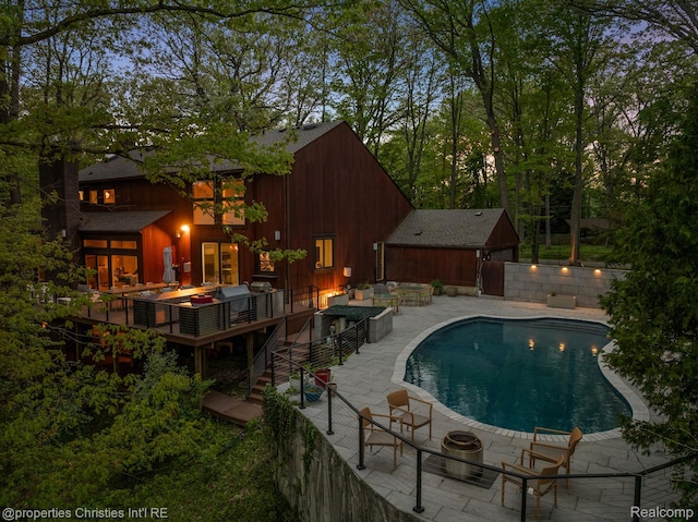 7371 Lindenmere Dr, Bloomfield Hills, MI 48301 - view of pool with a patio area, a wooden deck, and an outdoor living space with a fire pit