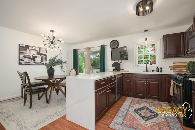 3051 Lantana Ct SE, Kentwood, MI 49512 - kitchen featuring black range with gas cooktop, a sink, a peninsula, stainless steel dishwasher, and light countertops