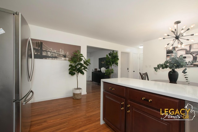 3051 Lantana Ct SE, Kentwood, MI 49512 - kitchen featuring freestanding refrigerator, a chandelier, light countertops, wood finished floors, and baseboards