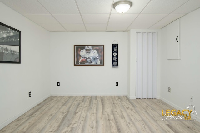 3051 Lantana Ct SE, Kentwood, MI 49512 - unfurnished room with a paneled ceiling, wood finished floors, and baseboards