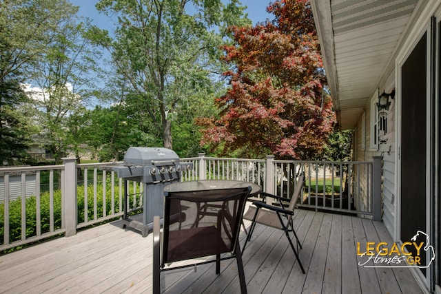 3051 Lantana Ct SE, Kentwood, MI 49512 - wooden terrace featuring outdoor dining space, grilling area, and view of wooded area