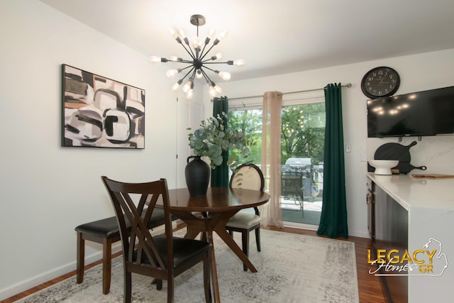3051 Lantana Ct SE, Kentwood, MI 49512 - dining space featuring a chandelier, wood finished floors, and baseboards