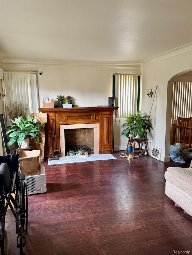 15898 Asbury Park, Detroit, MI 48227 - living room featuring a fireplace with flush hearth, ornamental molding, arched walkways, wood finished floors, and baseboards