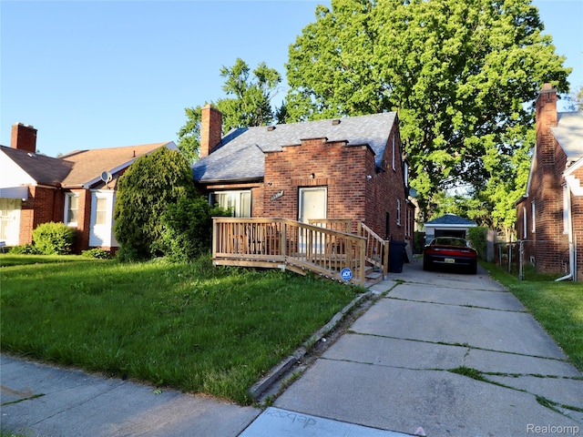 15898 Asbury Park, Detroit, MI 48227 - view of front of house with a front lawn, brick siding, a chimney, and concrete driveway