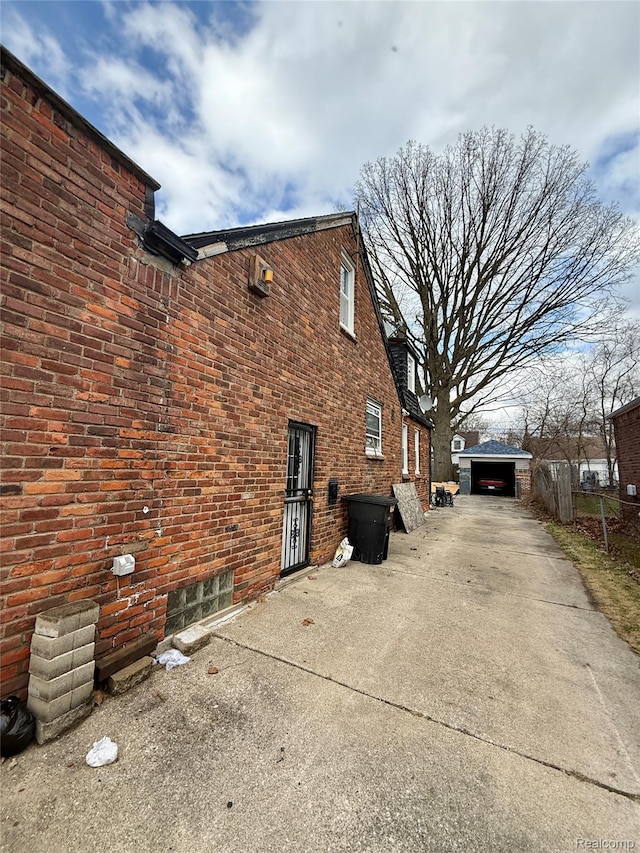 15898 Asbury Park, Detroit, MI 48227 - view of home's exterior with brick siding, an outdoor structure, and a detached garage