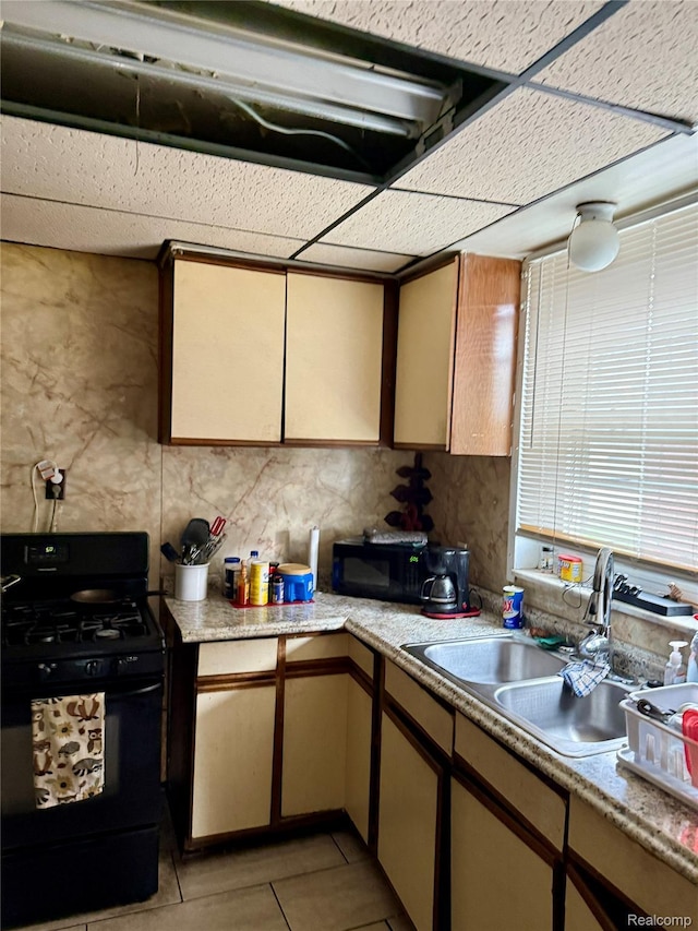 15898 Asbury Park, Detroit, MI 48227 - kitchen with black appliances, a sink, light countertops, and light tile patterned flooring