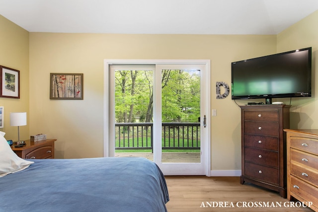 16993 Firefly Rdg, West Olive, MI 49460 - bedroom with access to exterior, light wood finished floors, and baseboards