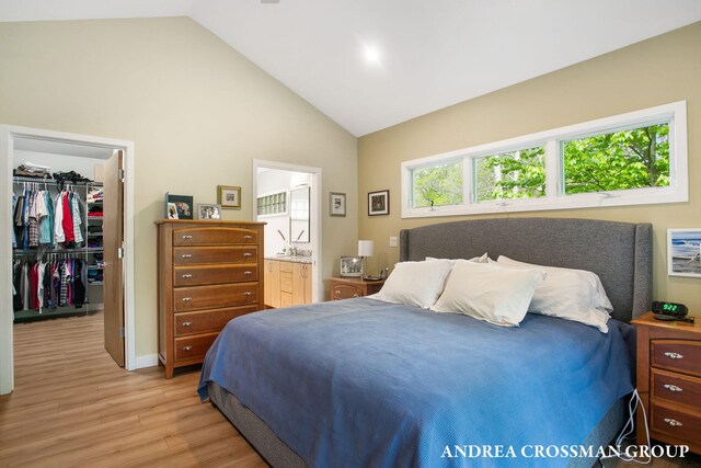 16993 Firefly Rdg, West Olive, MI 49460 - bedroom with a spacious closet, light wood finished floors, connected bathroom, a closet, and high vaulted ceiling