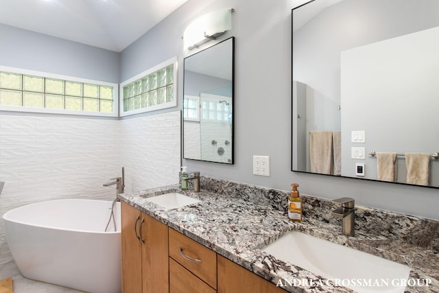 16993 Firefly Rdg, West Olive, MI 49460 - full bathroom featuring a freestanding tub and double vanity