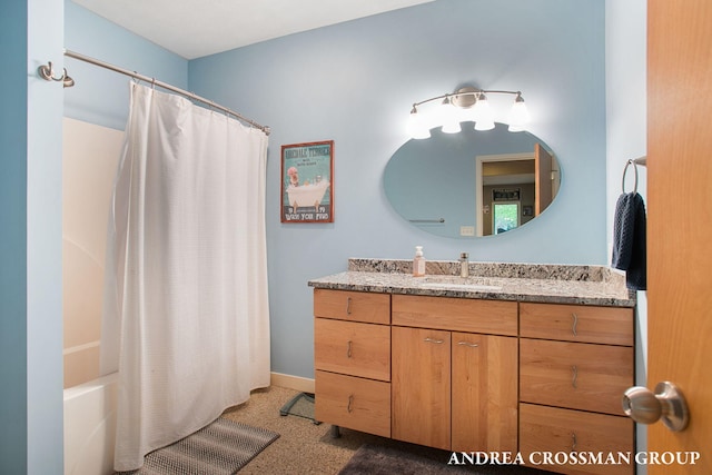 16993 Firefly Rdg, West Olive, MI 49460 - bathroom with vanity, baseboards, speckled floor, and shower / bathtub combination with curtain