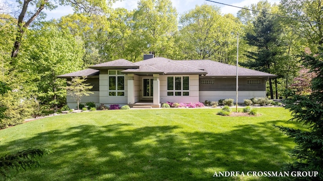 16993 Firefly Rdg, West Olive, MI 49460 - prairie-style house featuring a front lawn, a chimney, and roof with shingles