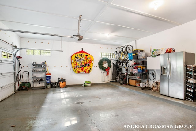 16993 Firefly Rdg, West Olive, MI 49460 - garage with stainless steel refrigerator with ice dispenser and a garage door opener