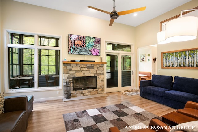 16993 Firefly Rdg, West Olive, MI 49460 - living room with wood finished floors, ceiling fan, a towering ceiling, a fireplace, and recessed lighting
