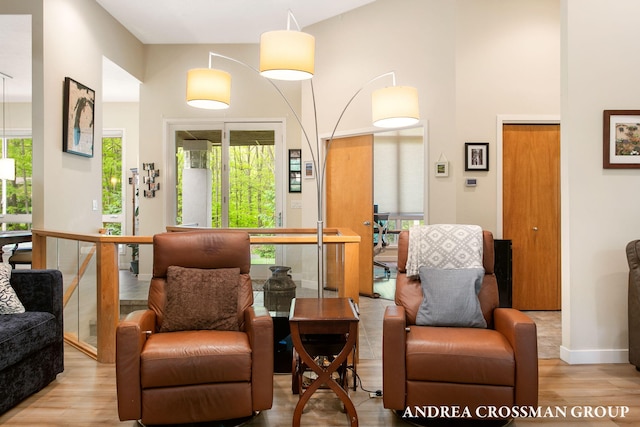 16993 Firefly Rdg, West Olive, MI 49460 - living area with wood finished floors, healthy amount of natural light, a high ceiling, and baseboards
