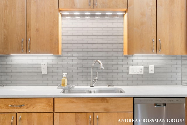 16993 Firefly Rdg, West Olive, MI 49460 - kitchen with stainless steel dishwasher, a sink, backsplash, and light countertops