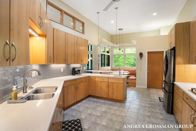 16993 Firefly Rdg, West Olive, MI 49460 - kitchen with a sink, decorative backsplash, a peninsula, light countertops, and recessed lighting