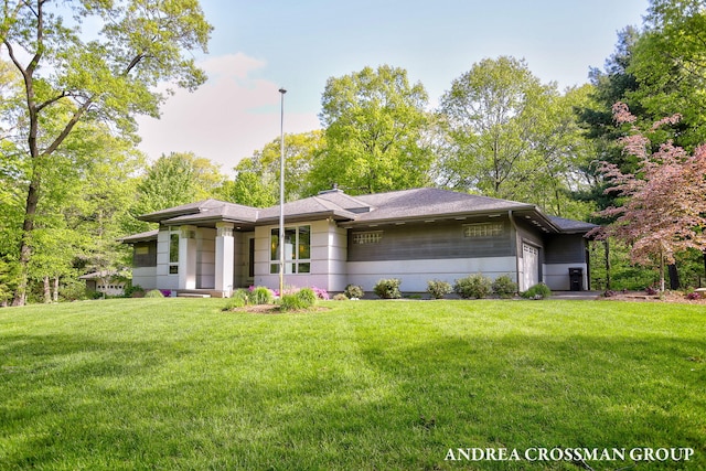 16993 Firefly Rdg, West Olive, MI 49460 - prairie-style house featuring an attached garage, a front yard, and a shingled roof