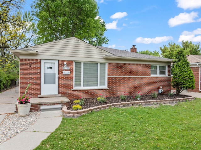 19140 Florence St, Roseville, MI 48066 - bungalow-style house featuring brick siding, a front yard, and a chimney