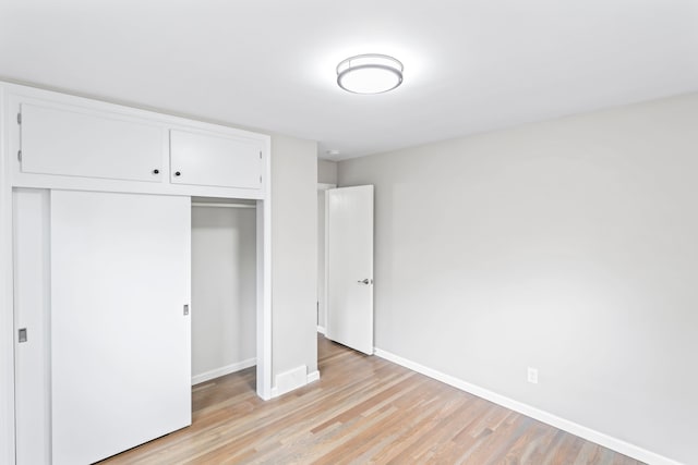 19140 Florence St, Roseville, MI 48066 - unfurnished bedroom with a closet, light wood finished floors, and baseboards