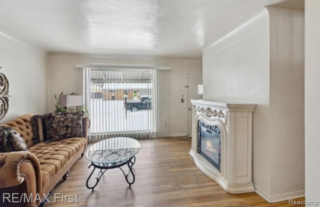 26914 Glendale, Redford, MI 48239 - living area featuring light wood-style floors, a glass covered fireplace, and baseboards