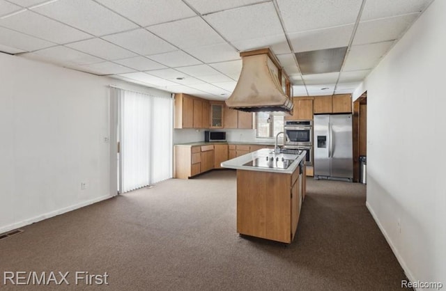 26914 Glendale, Redford, MI 48239 - kitchen with appliances with stainless steel finishes, a paneled ceiling, dark colored carpet, baseboards, and a kitchen island with sink
