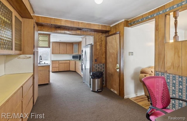 26914 Glendale, Redford, MI 48239 - kitchen featuring stainless steel appliances, dark colored carpet, light countertops, wooden walls, and a sink