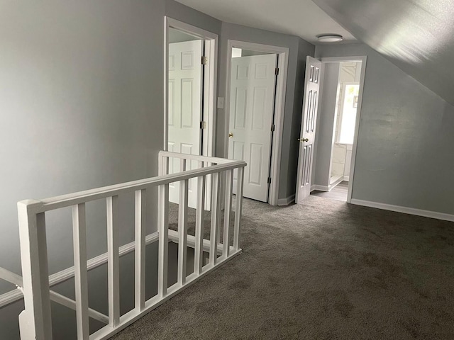 19943 Southfield Fwy, Detroit, MI 48235 - corridor with dark colored carpet, an upstairs landing, baseboards, and vaulted ceiling