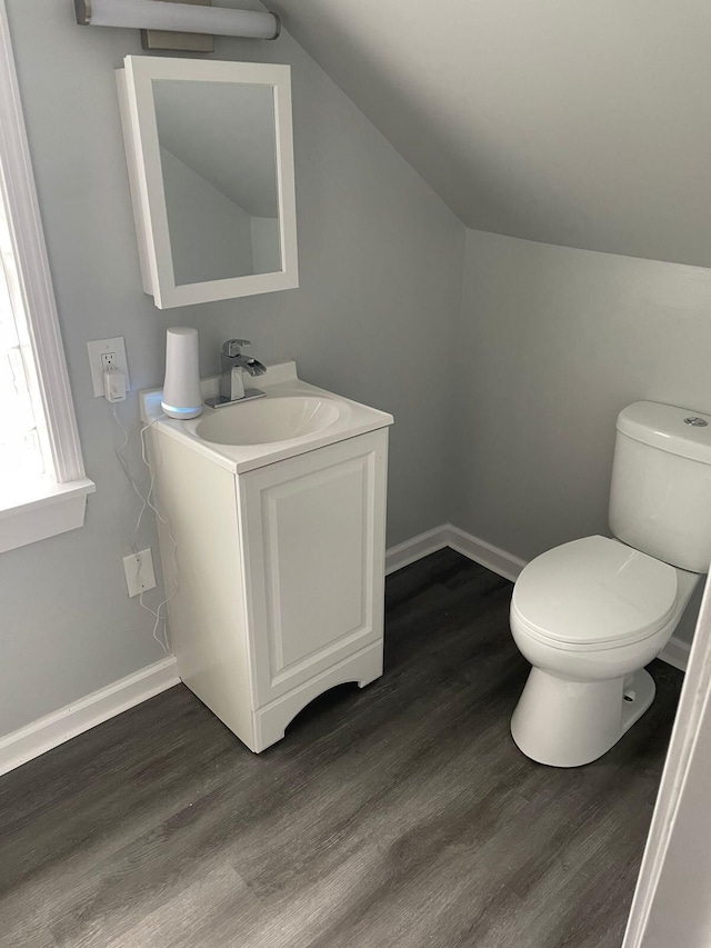 19943 Southfield Fwy, Detroit, MI 48235 - bathroom featuring toilet, lofted ceiling, wood finished floors, baseboards, and vanity