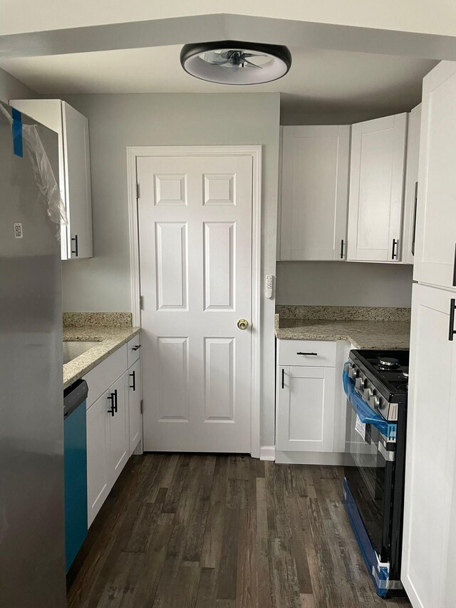 19943 Southfield Fwy, Detroit, MI 48235 - kitchen featuring range, dark wood finished floors, dishwashing machine, and white cabinets