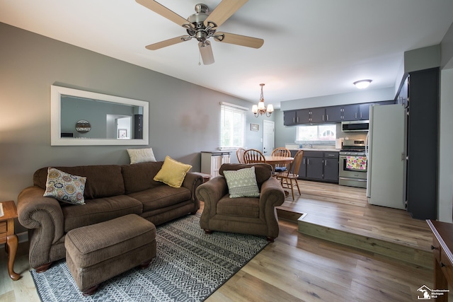 43800 Proctor Rd, Canton, MI 48188 - living room featuring a chandelier, a ceiling fan, and light wood-style floors