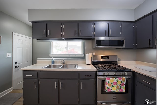 43800 Proctor Rd, Canton, MI 48188 - kitchen with appliances with stainless steel finishes, a sink, light countertops, and wood finished floors