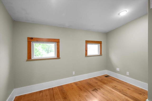 152 National Ave SW, Grand Rapids, MI 49504 - spare room featuring plenty of natural light, baseboards, and wood finished floors