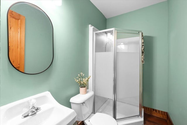 152 National Ave SW, Grand Rapids, MI 49504 - bathroom with a sink, a stall shower, and toilet
