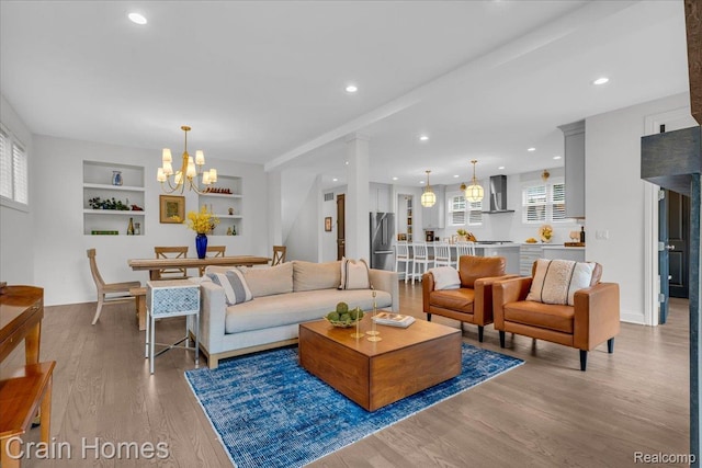 1748 Stanley Blvd, Birmingham, MI 48009 - living area with light wood-type flooring, built in features, recessed lighting, and a chandelier