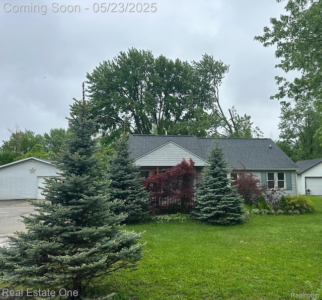 5399 Brobeck St, Flint, MI 48532 - view of front of house featuring a front yard, an outdoor structure, a garage, and concrete driveway