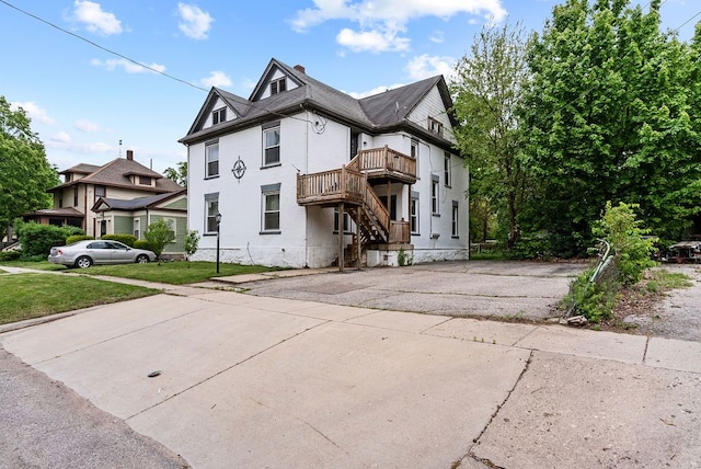 612 E 3rd St, Flint, MI 48503 - view of front facade with asphalt driveway and a chimney